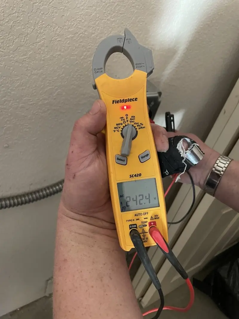 Voltage testing with clamp meter during Outlet Installation in Crete